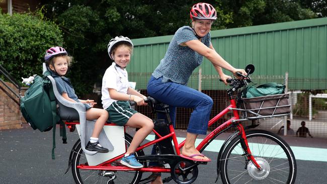 Sally McGeoch with Ruby and Evie riding their electric bike to Clovelly Public School.