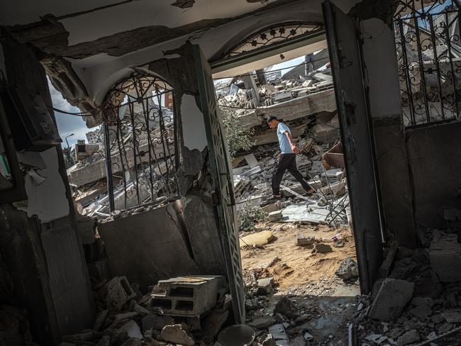 A man walks through rubble in Gaza City that was destroyed by an Israeli air strike. Picture: Fatima Shbair/Getty