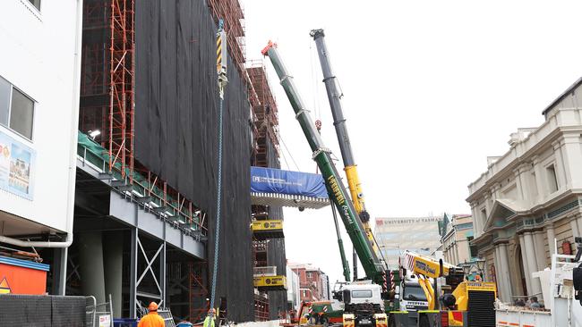 The new hyperbaric chamber is lifted into the Royal Hobart Hospital as part of the redevelopment. Picture: NIKKI DAVIS-JONES