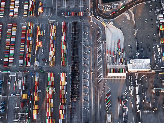 LOS ANGELES, CALIFORNIA - SEPTEMBER 20: In an aerial view, shipping containers and trucks are seen at the Port of Los Angeles on September 20, 2021 near Los Angeles, California. Amid a record-high demand for imported goods and a shortage of shipping containers and truckers, the twin ports of Los Angeles and Long Beach are currently seeing unprecedented congestion. On September 17, there were a record total of 147 ships, 95 of which were container ships, in the twin ports, which move about 40 percent of all cargo containers entering the U.S.   Mario Tama/Getty Images/AFP == FOR NEWSPAPERS, INTERNET, TELCOS & TELEVISION USE ONLY ==