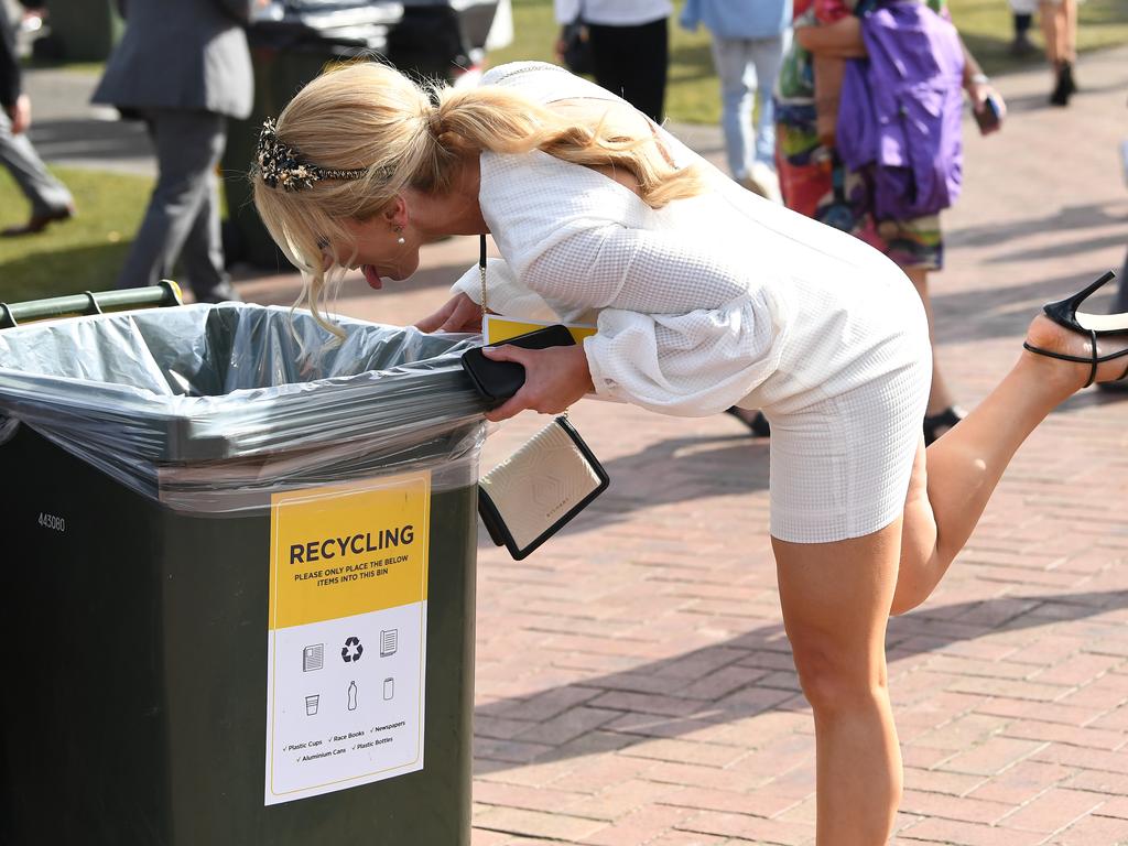 A woman pretends to vomit into a bin. Charming. Picture: Julian Smith/AAP