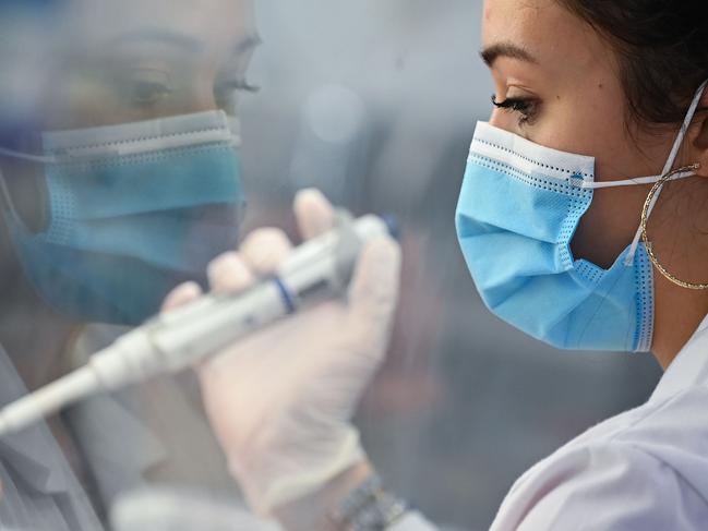 A laboratory technician uses a pipette device to process samples to test for the novel coronavirus Covid-19, at Biogroup Laboratory's lab in west London. Picture: AFP