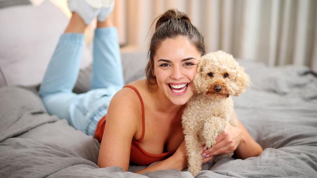 Neighbours star Olympia Valance with her beloved pet dog George. Picture: Mark Stewart