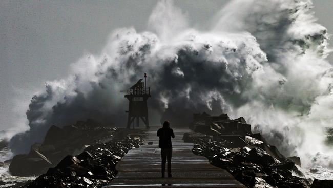 Newcastle's iconic Nobby's breakwall is smashed by the biggest seas of the summer. Picture by Peter Lorimer.