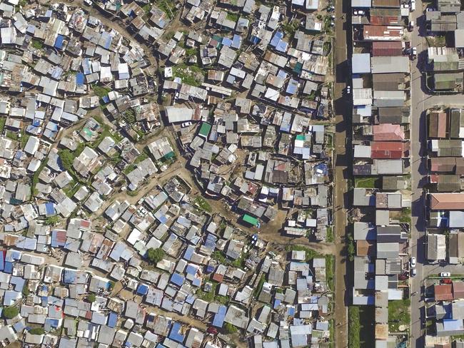 Unequal Scenes: Segregation of urban spaces in South Africa. Picture: Johnny Miller/Millefoto/Rex Shutterstock/Australscope