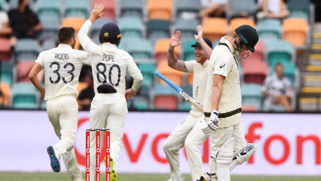 Mark Wood and England celebrate the wicket of Steve Smith on day three of the fifth Test. Picture: William WEST/AFP