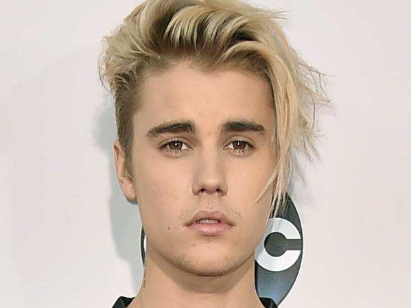 FILE - In this Sunday, Nov. 22, 2015 file photo, Justin Bieber arrives at the American Music Awards at the Microsoft Theater in Los Angeles. With his recent batch of hit singles and semi-grown-up sound - including the electro-pop "Where Are U Now" with DJ-producers Skrillex and Diplo - adult men have begun attending the church of Bieber, and while some have issues admitting it, other proudly say they are Beliebers. “Sorry” and “What Do You Mean,” currently at Nos. 2 and 4 on Billboard’s Hot 100 chart, helped Bieber solidify his comeback after years of a broken image, which included arrests, public smoking and fainting onstage that led to hospitalization. (Photo by Jordan Strauss/Invision/AP, File)