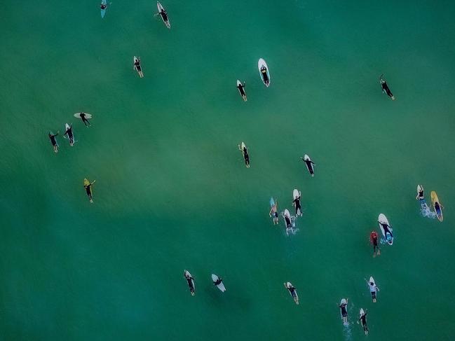 Friends farewelled Nick Slater during a paddle out at Newcastle. Picture: Matt Richards