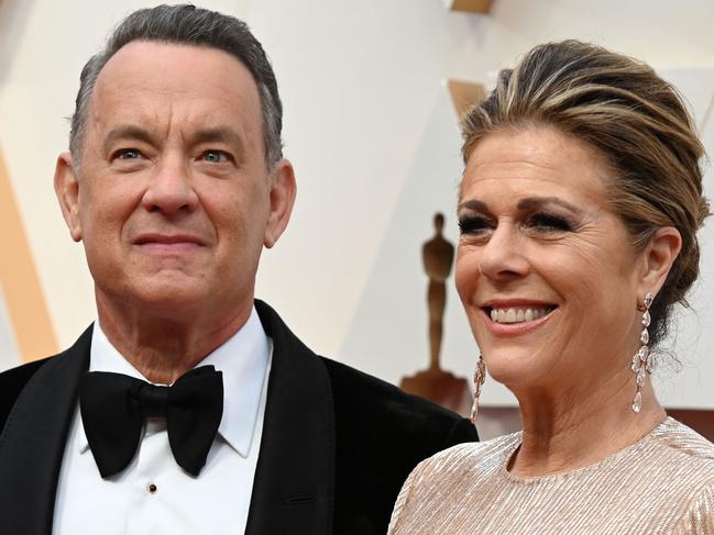 (FILES) In this file photo taken on February 9, 2020 US actor Tom Hanks and wife Rita Wilson arrive for the 92nd Oscars at the Dolby Theatre in Hollywood, California. - Hollywood megastar Tom Hanks said he and wife Rita Wilson were on the mend on March 23, 2020, after two weeks in hospital and self-isolation with the coronavirus. (Photo by Robyn Beck / AFP)