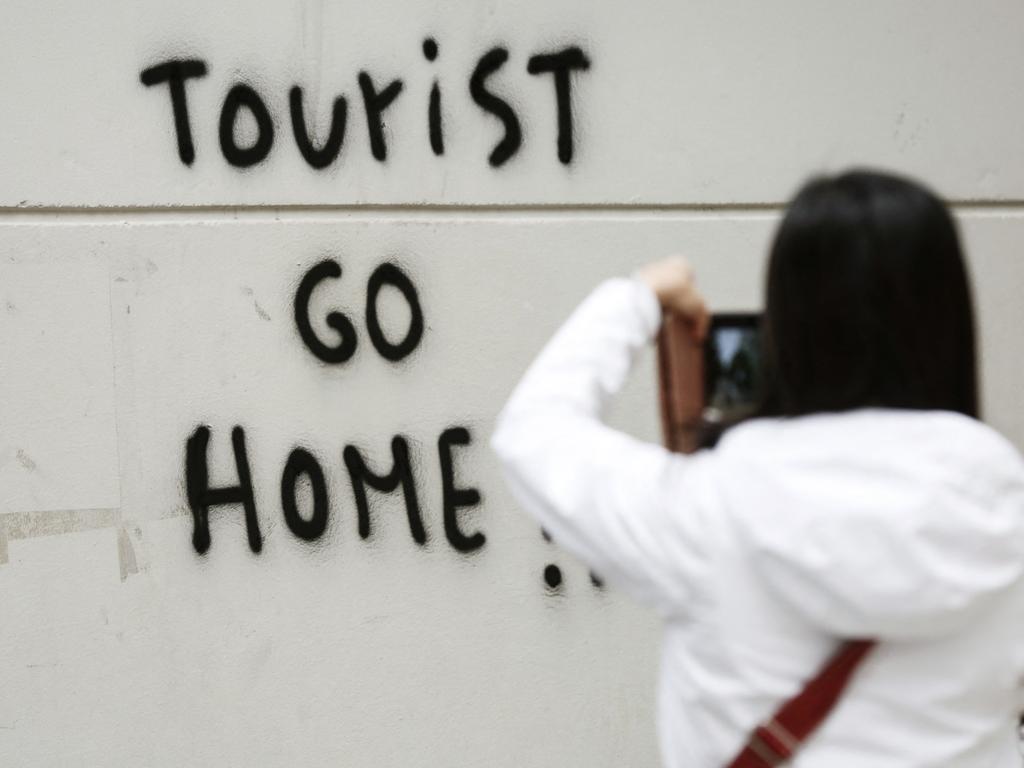 Hostile messages against foreigners can be found on the walls across various Spanish holiday spots. Picture: Pau Barrena / AFP