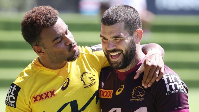 Ezra Mam showing some love for Adam Reynolds at Brisbane Broncos training. Picture: Liam Kidston