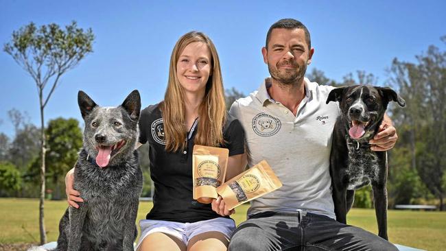 DOGGY SNACKS: Katharina von Heusinger and partner Reiner Adolfsen who have started a healthy dog treat bakery out of Borallon Correctional Facility, seen here with with dogs Winston and Jett. Picture: Cordell Richardson