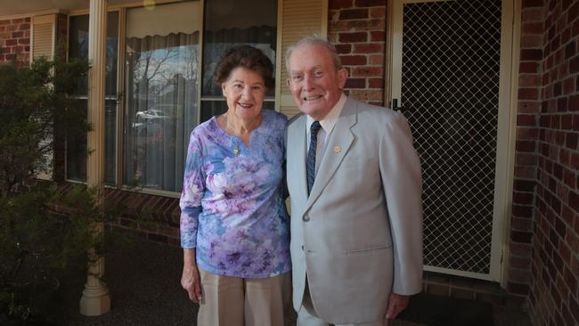 Mr Smith and his wife stand outside their Elderslie home after he was awarded for 50 years of service from the State Government. Picture: Robert Pozo