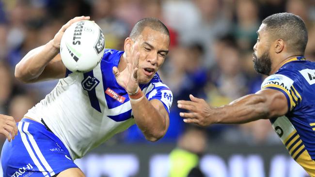 Will Hopoate of the Bulldogs is tackled by Michael Jennings of the Eels. Photo: AAP Image/Mark Evans