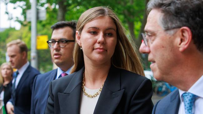 Ms Higgins leaves the Federal Court, in Sydney, with Mr Sharaz and Mr Zwier Picture: Justin Lloyd.