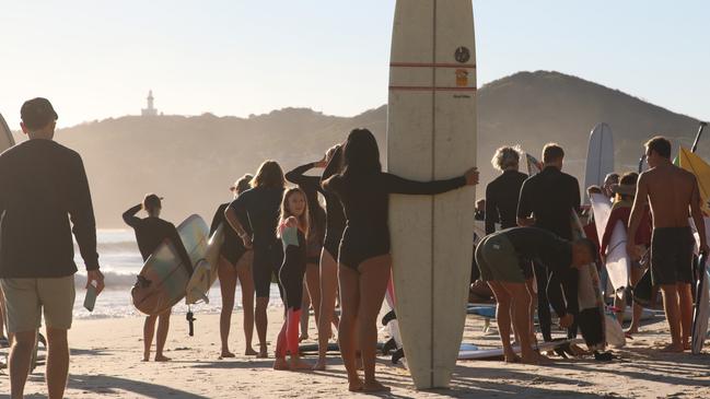 Members of the public prepare for a paddle-out at Byron Bay's Main Beach to protest against the planned Netflix reality show Byron Baes on Tuesday. Picture: Liana Boss