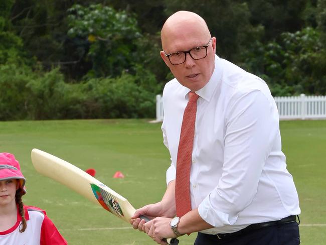 BRISBANE, AUSTRALIA - NewsWire Photos SEPTEMBER 19, 2024: The Leader of the Opposition Peter Dutton bats as Olivia, 7, looks on during a visit to the Valley District cricket club in Ashgrove. Picture: NewsWire/Tertius Pickard