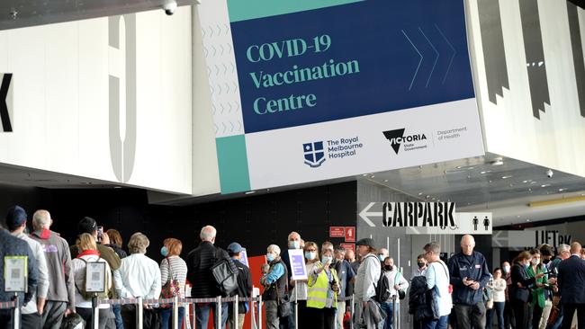 People queue at the Melbourne Convention and Exhibition Centre for their AstraZeneca Covid vaccination. Picture: Andrew Henshaw