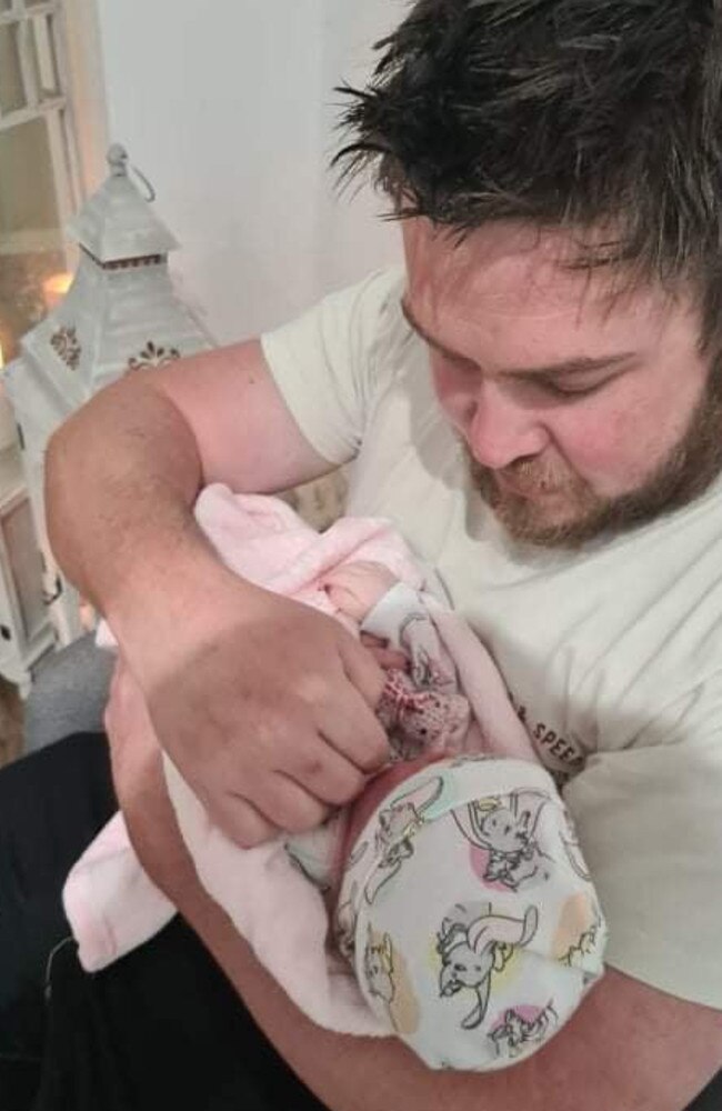 A devastated Aaron Harrison, 33, of Bahrs Scrub visits his newborn daughter, Sophie, in the viewing room at Farewell Funerals in Meadowbrook before her cremation last year. Sophie was stillborn on her due date following complications with a Strep B infection. Picture: Supplied