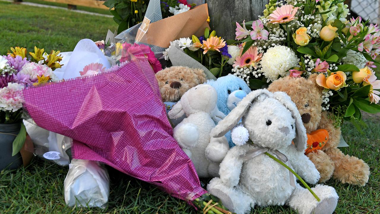 A memorial of flowers and toys for Hannah Baxter and her three kids on a Camp Hill street. Picture: John Gass/AAP