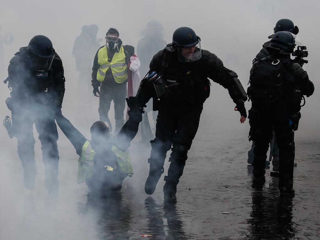 Riot police detain a protester in the third weekend of clashes with Yellow Vests in Paris demonstrating against rising oil prices and living costs. Picture: Abdulmonam Eassa/AFP