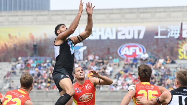 Paddy Ryder of the Power takes a grab in front of Jarrod Witts of the Suns during last year’s match between Gold Coast and Port Adelaide at Jiangwan Stadium in Shanghai, China. Picture: AAP Image/Tracey Nearmy