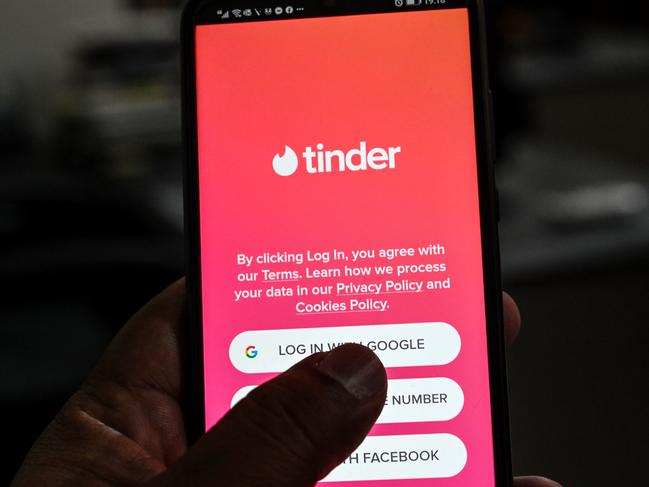 In this picture taken on October 6, 2020, a user checks the dating app Tinder on a mobile phone in Islamabad. - Unlike in many countries where meeting online is routine, Pakistanis who use dating apps regularly face harassment and judgmental relatives -- and now also have to contend with a government clampdown. (Photo by Aamir QURESHI / AFP) / To go with 'PAKISTAN-MARRIAGE-DATING', FOCUS by David Stout and Kaneez Fatima in Lahore