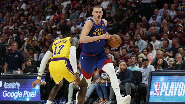 Nikola Jokic #15 of the Denver Nuggets drives to the basket against Dennis Schroder #17 of the Los Angeles Lakers during the third quarter in game one of the Western Conference Finals at Ball Arena on May 16, 2023 in Denver, Colorado. (Photo by Matthew Stockman/Getty Images)