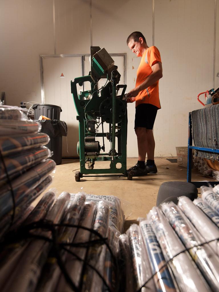 Delivery man Matthew Fricker prepares the paper for delivery at the NT News during the printing process. Pictures: KERI MEGELUS