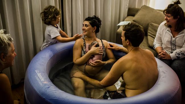 A family’s delight after a water birth. The national midwifery guidelines list a 100kg weight limit for mums. Picture: Anna Todd.