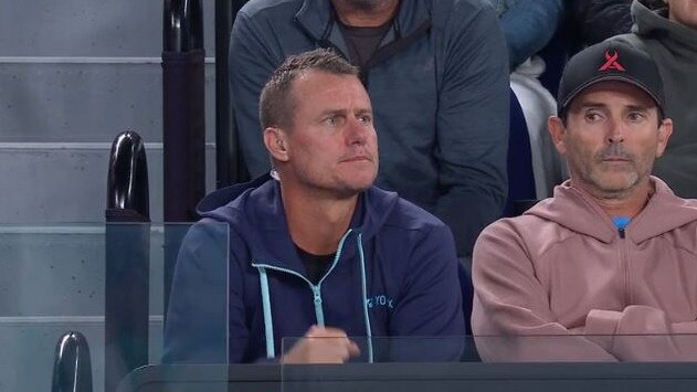 Lleyton Hewitt watching Alex de Minaur.