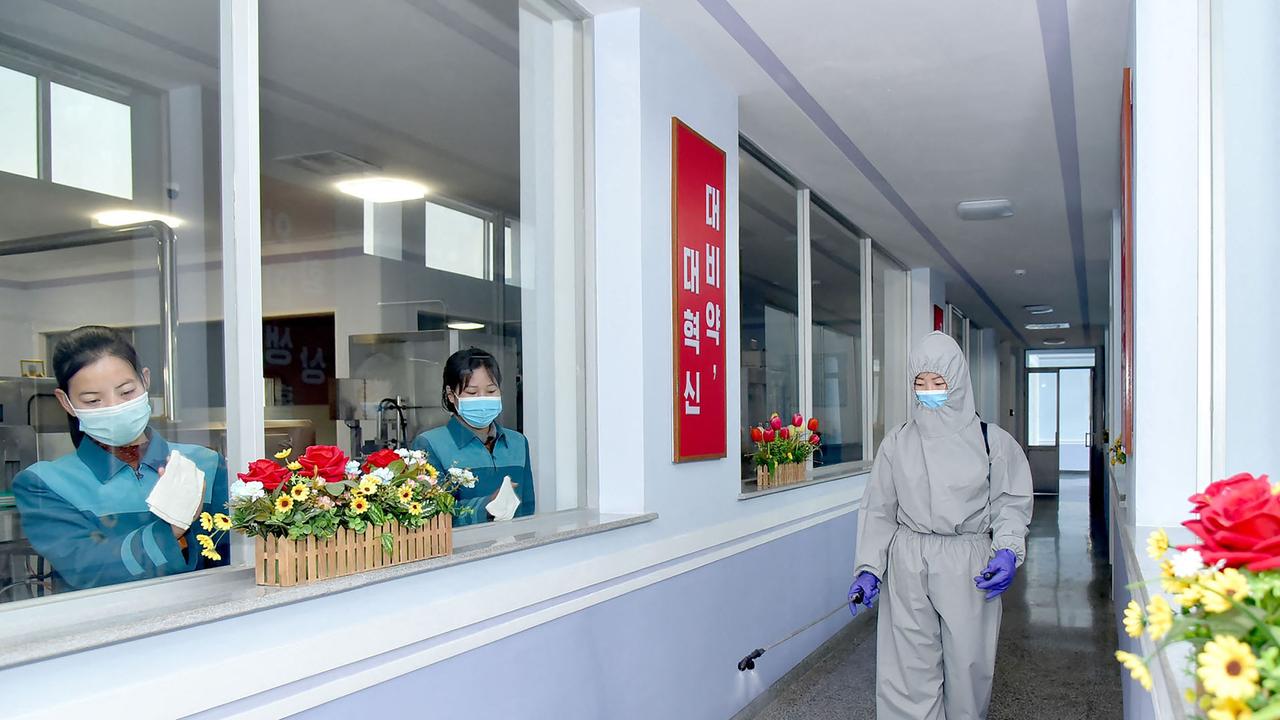 Official picture released from North Korea showing shows employees disinfecting facility as a quarantine measure. Picture: AFP.