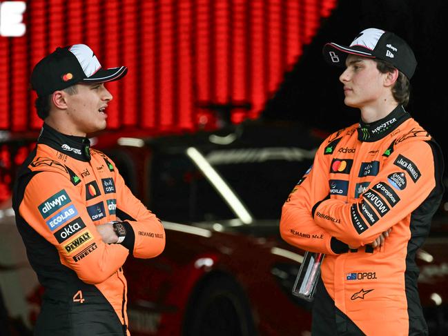 TOPSHOT - McLaren's British driver Lando Norris (L), who came in second, talks to McLaren's Australian driver Oscar Piastri, who came in third, after the qualifying session of the Formula One Japanese Grand Prix at the Suzuka circuit in Suzuka, Mie prefecture on April 5, 2025. (Photo by MOHD RASFAN / AFP)