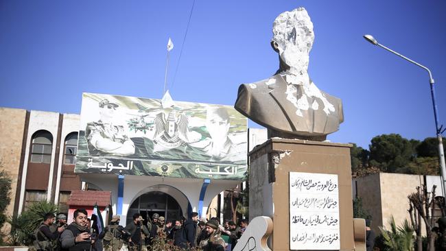 Anti-government fighters gather in front of the Kuweires military airfield and academy in the eastern part of Aleppo province on December 1. Picture: Aref Tammawi/AFP