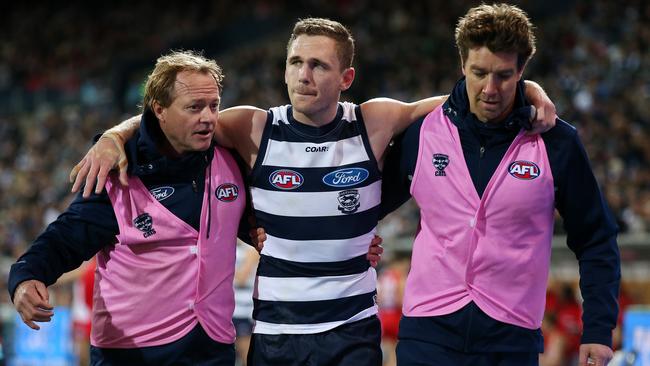 Geelong's Joel Selwood in the hands of trainers after a second-quarter injury. Picture: Michael Klein