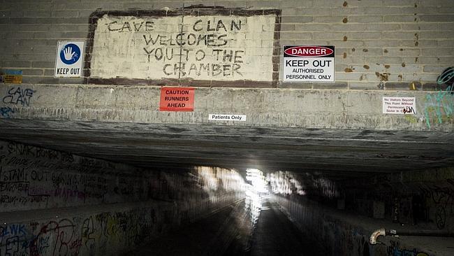 A Cave Clan sign in a storm water drain under the surface of Melbourne. Picture: Jason Ed