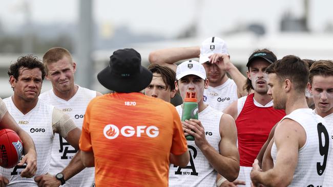 Port players, including Steven Motlop, Tom Clurey and Connor Rozee, listen to coach Ken Hinkley in Queensland. Picture: Sarah Reed