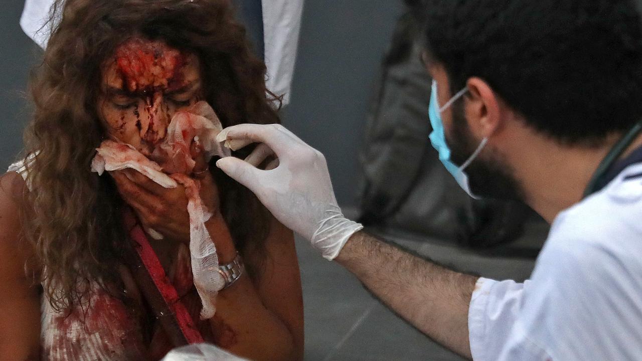 A medic tends to a woman’s injuries. Picture: Ibrahim Amro/AFP