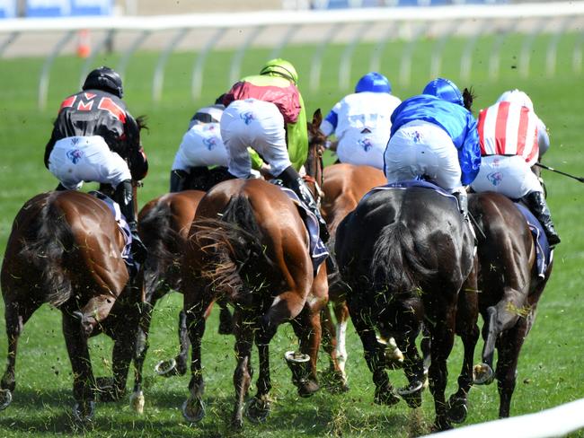 MELBOURNE, AUSTRALIA - OCTOBER 02: Damien Oliver riding Kementari (r) winning Race 4, the Gilgai Stakes during Melbourne Racing at Flemington Racecourse on October 02, 2021 in Melbourne, Australia. (Photo by Vince Caligiuri/Getty Images)