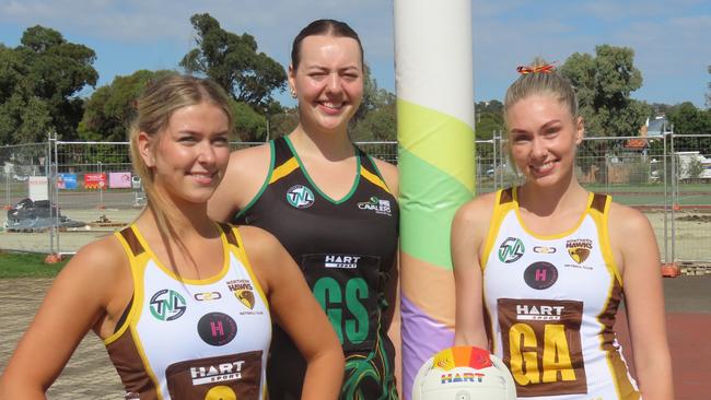 Hawks under-19s player Olivia Bender, Cavaliers captain Hayley McDougall and Hawks shooter Dani Laugher before the TNL grand final rematch in Friday night's Pride Round. Picture: Jon Tuxworth