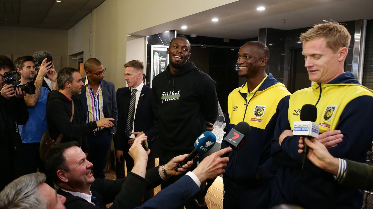 Usain Bolt speaks to the media with Mariners teammates Kalifa Cisse and Matt Simon.