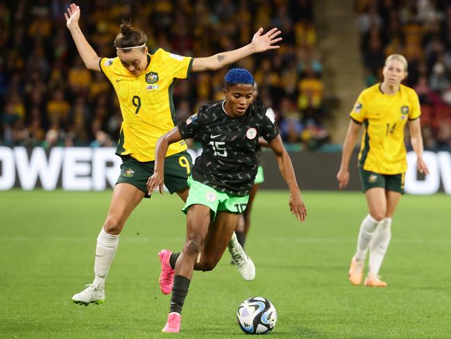 Caitlin Foord and Rasheedat Ajibade compete for the ball during the FIFA WomenÃs World Cup group stage match between Australia and Nigeria at Brisbane Stadium. Picture Lachie Millard