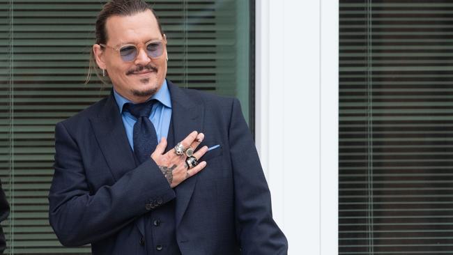 Johnny Depp gestures to fans during a recess outside court during the Johnny Depp and Amber Heard civil trial. Picture: Cliff Owen/Consolidated News Pictures/Getty Images