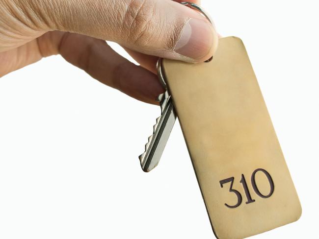 guest holding the hotel room key isolated on white background