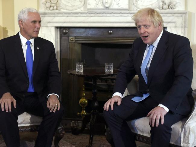 Boris Johnson looked relieved to have a meeting with Mike Pence as his leadership remained on a knife’s edge. Picture: AP