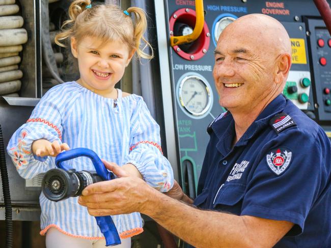 Lily enjoys a special visit from her grandfather Andrew Wheeler in his firetruck. Picture: Angelo Velardo