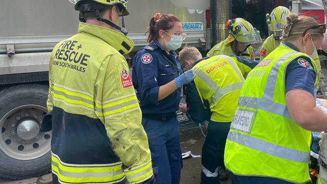 The woman had to be extricated from under the large truck by paramedics and Fire and Rescue crews. Picture: CareFlight