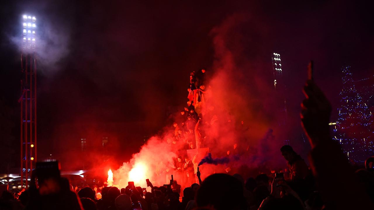 French supporters light flares as they celebrate their team's victory over England in the Qatar 2022 World Cup quarter-final football match in Montpellier on December 10, 2022. (Photo by Sylvain THOMAS / AFP)