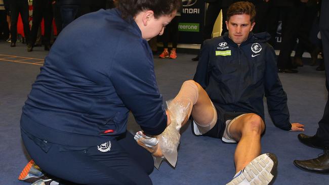 Marc Murphy has ice applied to his ankle after taking off the moon boot he wore while sitting on the bench. Picture: Getty