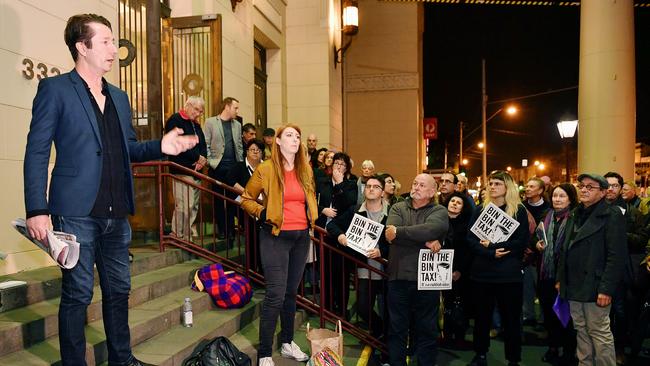 Cr Stephen Jolly addresses a bin tax protest at Richmond Town Hall. Picture: Jake Nowakowski